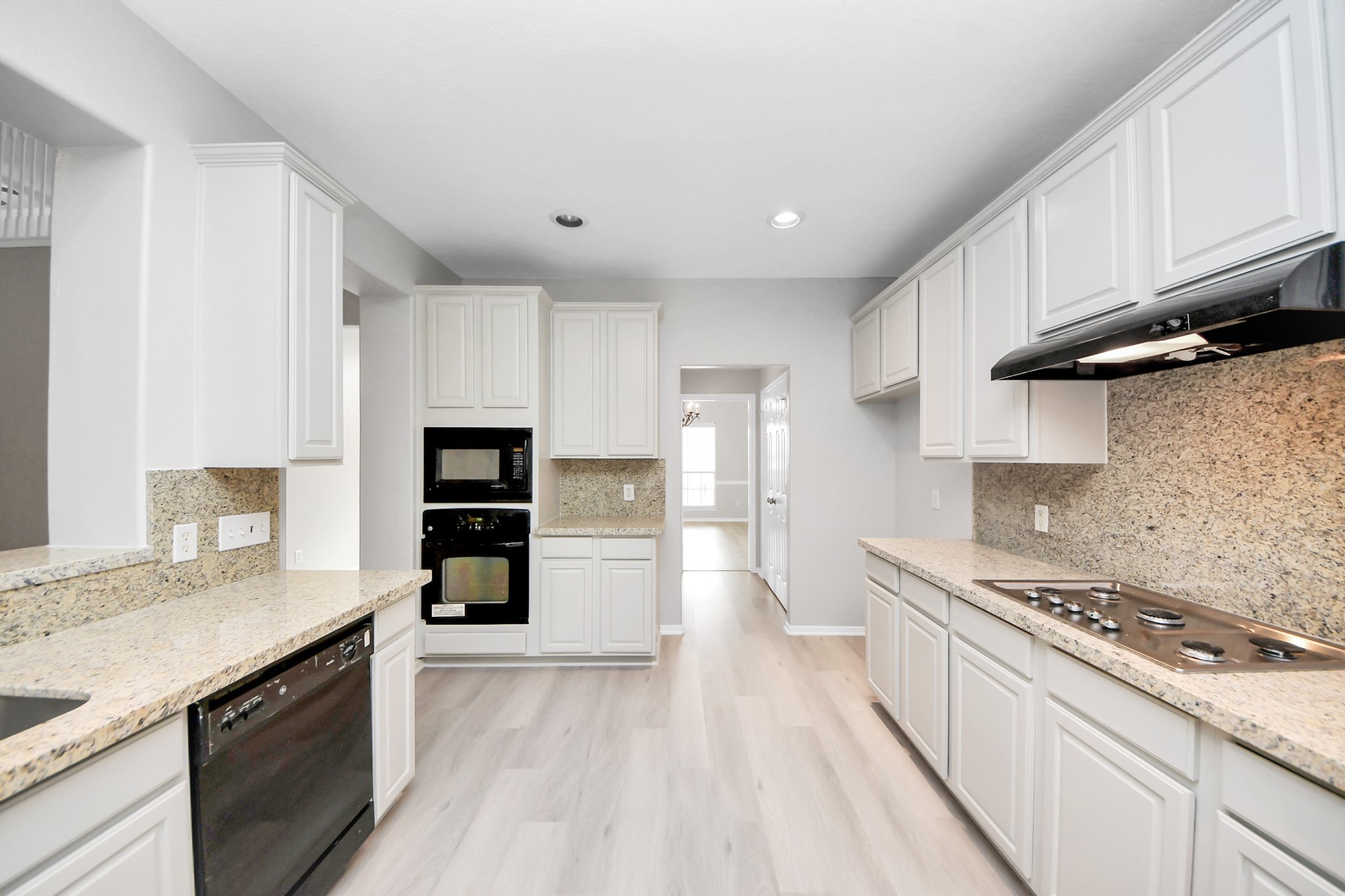 6803 Chapelfield Lane Houston, TX 77049 - Photo 17 of 50 a large kitchen with stainless steel appliances granite countertop a stove and a sink
