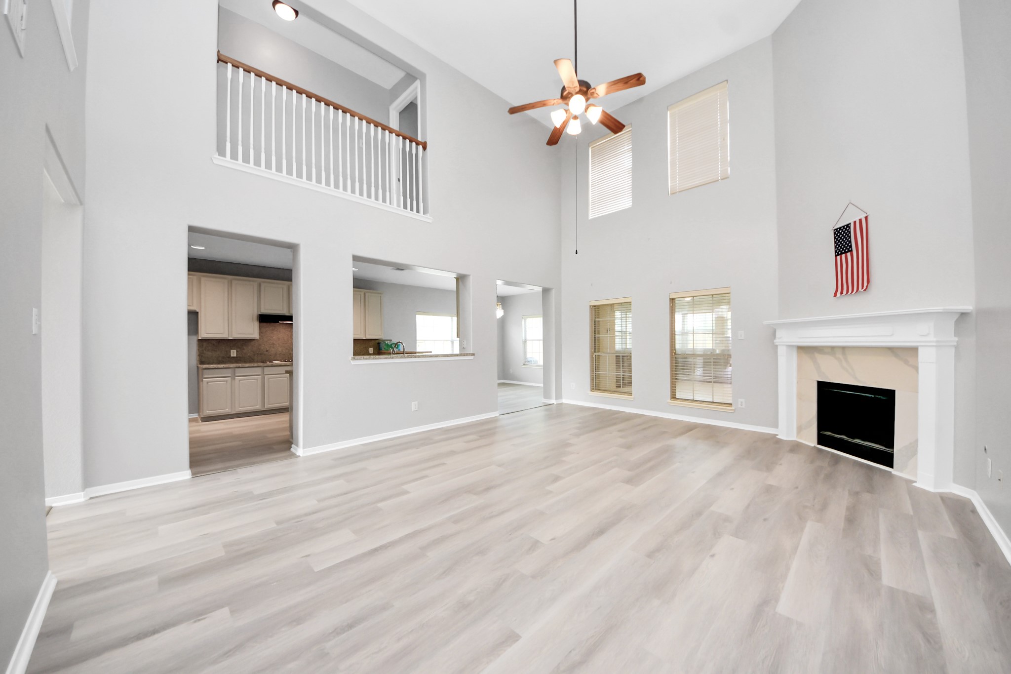 6803 Chapelfield Lane Houston, TX 77049 - Photo 23 of 50 a view of an empty room with chandelier fan and fire place