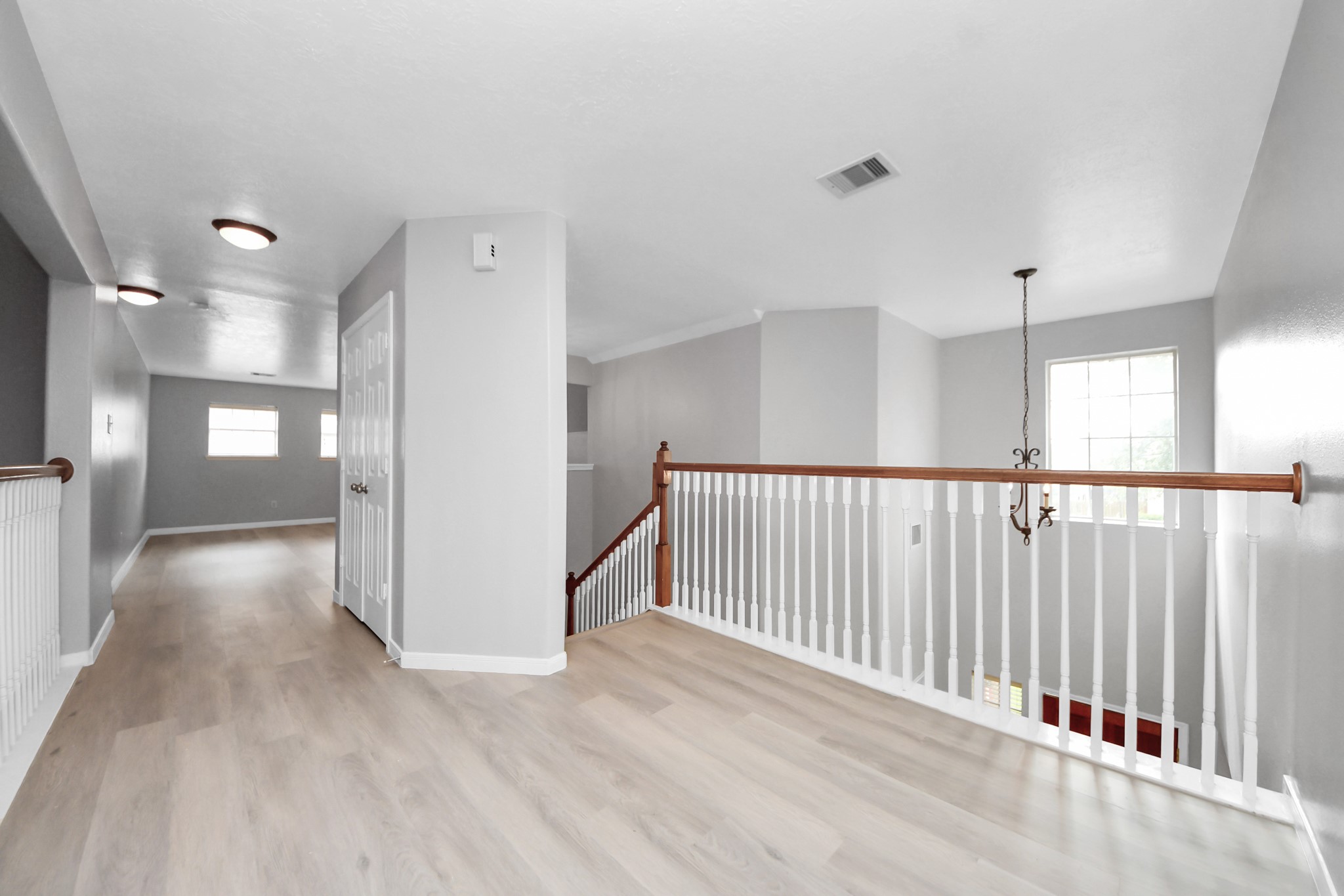 6803 Chapelfield Lane Houston, TX 77049 - Photo 25 of 50 a view of a hallway with wooden floor and windows