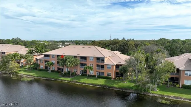an aerial view of a house with swimming pool and lake view
