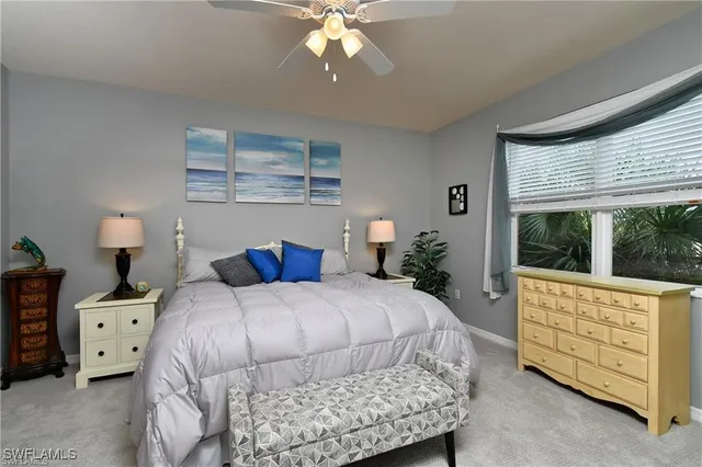 a bedroom with a large bed and a large window