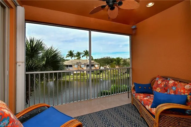 a front view of a house with a yard and a large pool table and chairs
