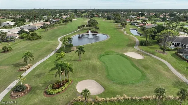 an aerial view of a house with a yard and lake view