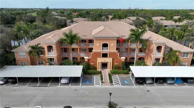 an aerial view of multiple houses with a yard