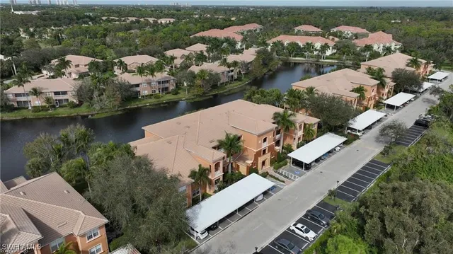 an aerial view of residential houses with outdoor space and lake view