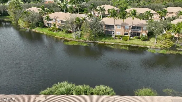 an aerial view of a house with garden space and lake view