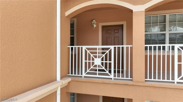 a view of a hallway with furniture and front door