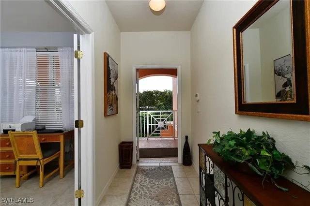 a living room with furniture a window and a potted plant