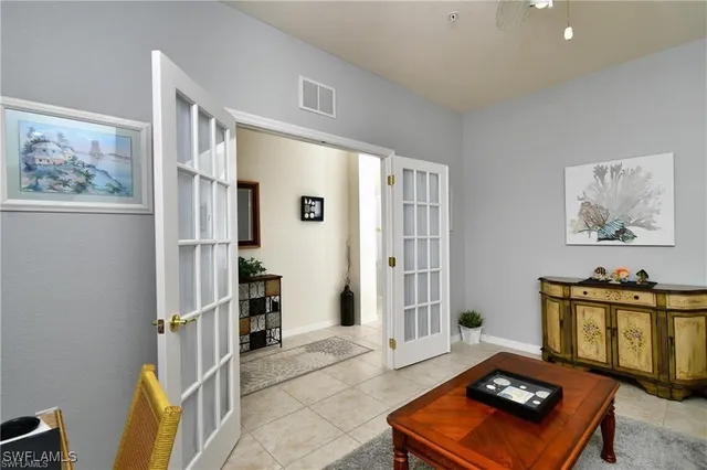 a bedroom with a bed and a lamp