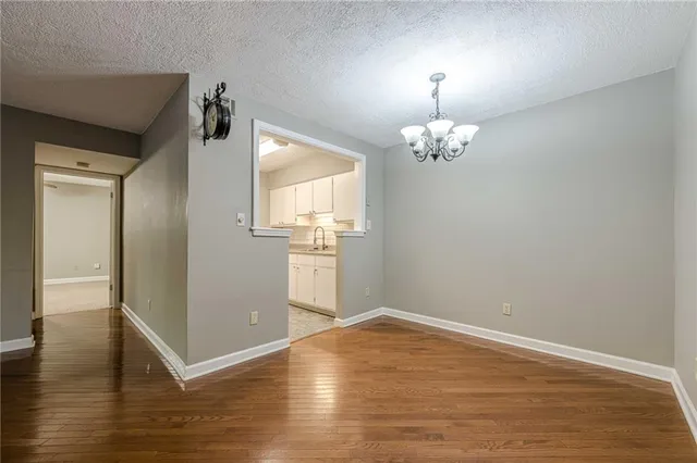 a view of room with wooden floor