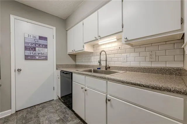 a kitchen with sink cabinets and appliances