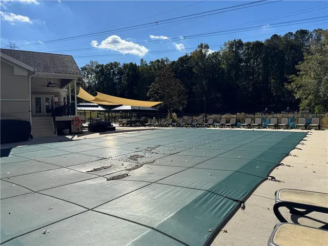 a patio with a table and chairs under an umbrella