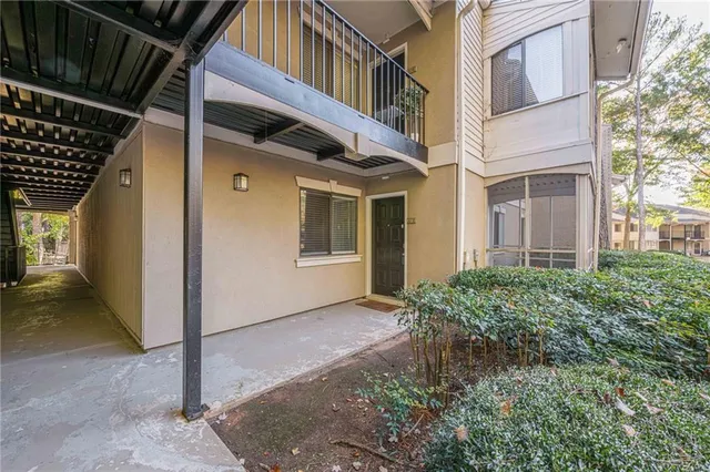 a view of empty room with wooden floor and floor to ceiling window