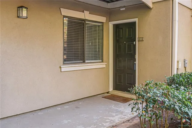 a view of empty room with wooden floor and floor to ceiling window