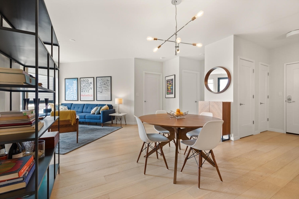 45 West 3rd Street, Unit 512 Boston, MA 02127 - Photo 13 of 40 a living room with furniture a piano and a bookshelf