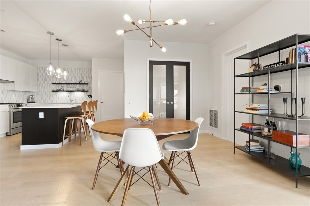 45 West 3rd Street, Unit 512 Boston, MA 02127 - Photo 15 of 40 a dining room with furniture and a chandelier
