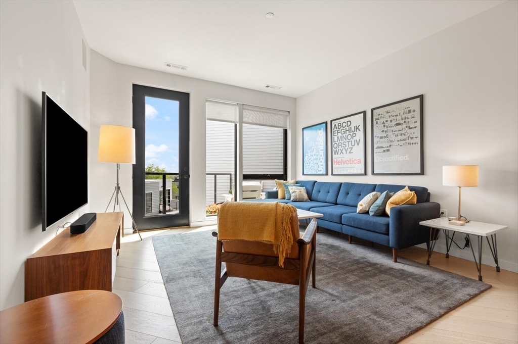 45 West 3rd Street, Unit 512 Boston, MA 02127 - Photo 2 of 40 a living room with furniture and a flat screen tv