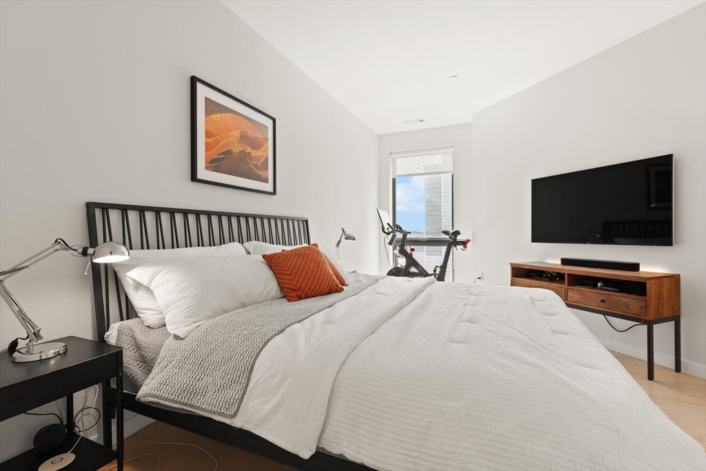45 West 3rd Street, Unit 512 Boston, MA 02127 - Photo 22 of 40 a bedroom with bed table and flat screen tv