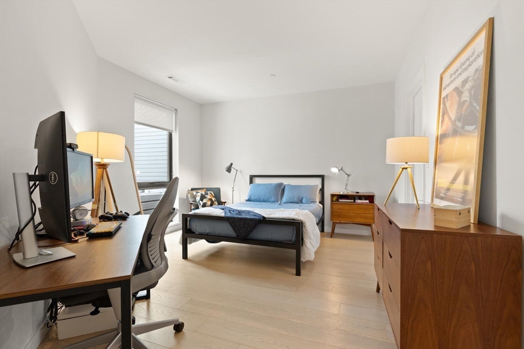 45 West 3rd Street, Unit 512 Boston, MA 02127 - Photo 25 of 40 a bedroom with furniture and a flat screen tv