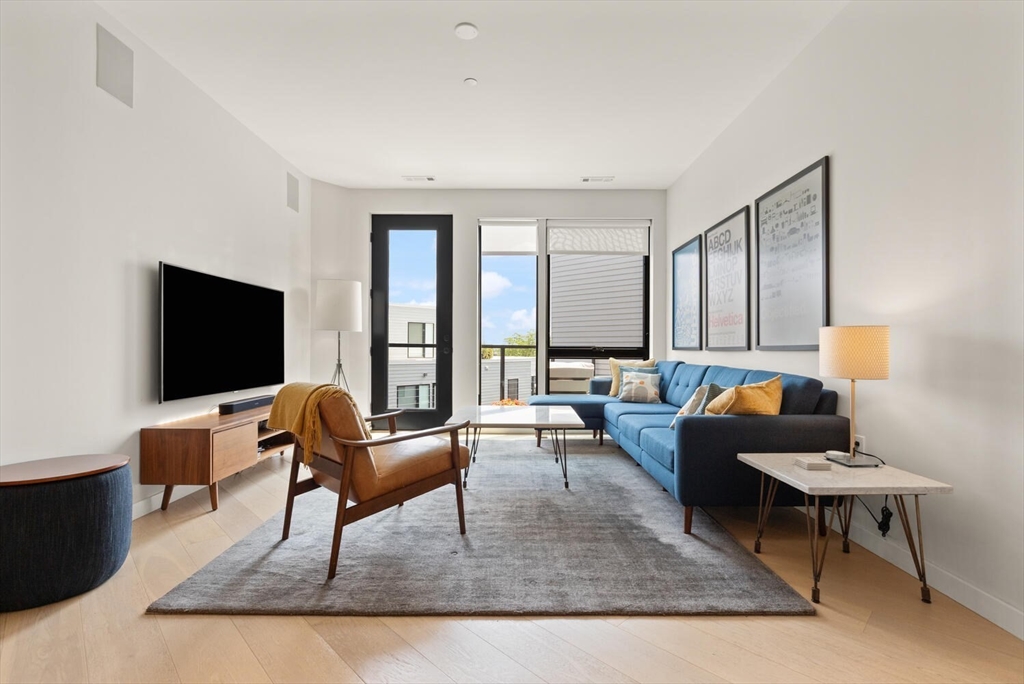 45 West 3rd Street, Unit 512 Boston, MA 02127 - Photo 4 of 40 a living room with furniture and a flat screen tv