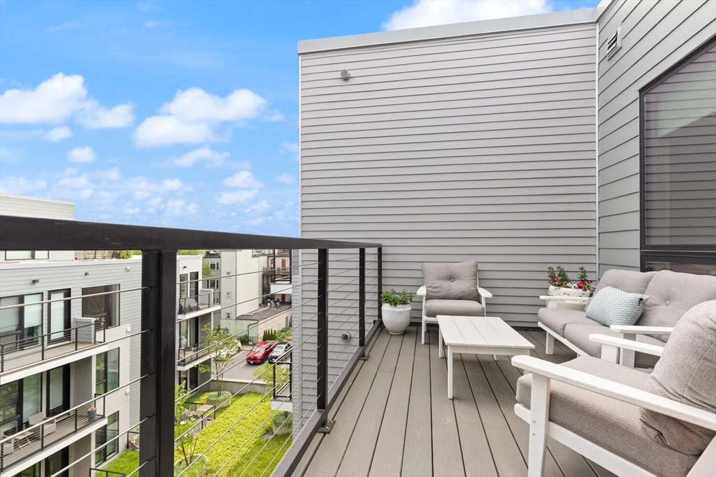 45 West 3rd Street, Unit 512 Boston, MA 02127 - Photo 6 of 40 a balcony with wooden floor and outdoor seating