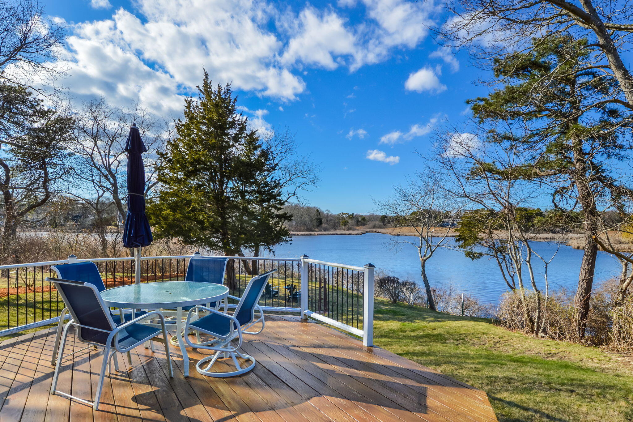 20 Stanley Place Hyannis, MA 02601 - Photo 4 of 37 a view of a patio with table and chairs with wooden fence and floor