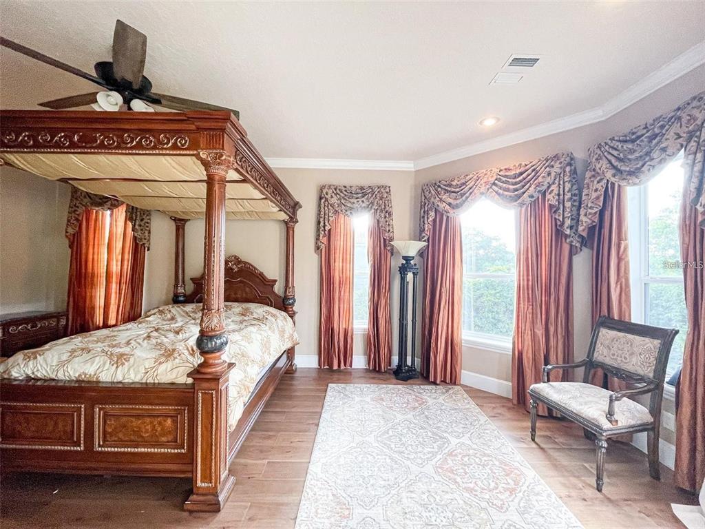 13161 Lake Butler Boulevard Windermere, FL 34786 - Photo 13 of 30 a bed sitting in a spacious bedroom next to a window