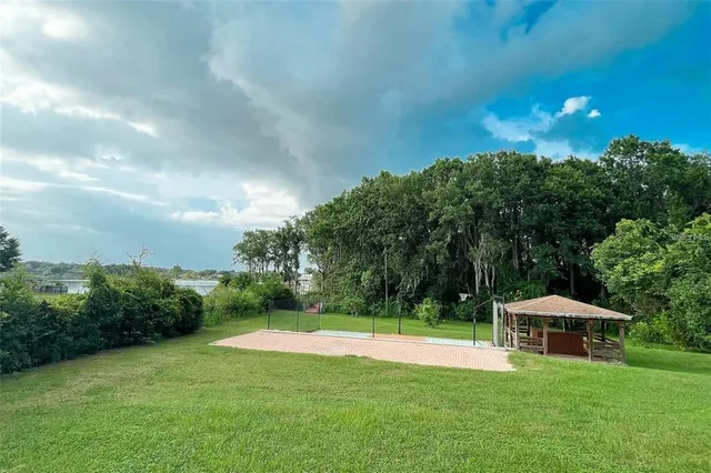 a view of a house with a yard and sitting area