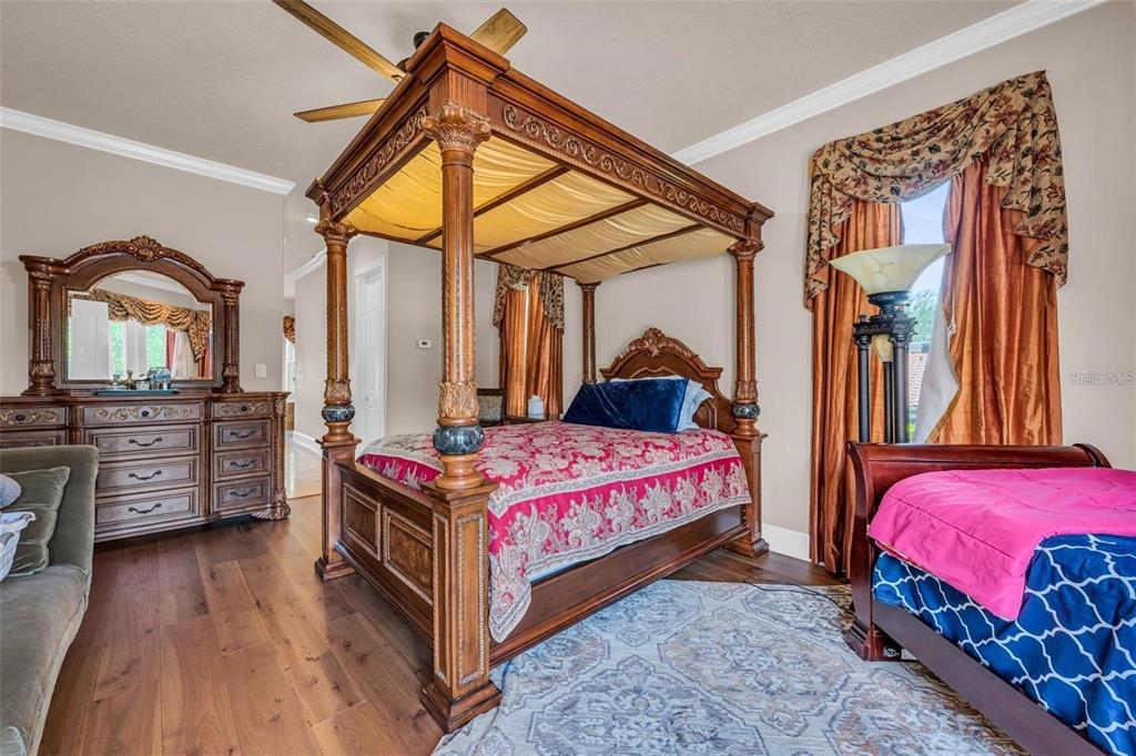 13161 Lake Butler Boulevard Windermere, FL 34786 - Photo 20 of 30 a bedroom with a bed and wooden floor