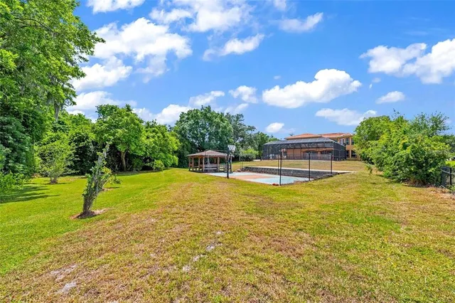 a swimming pool with trees in the background