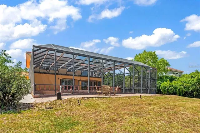 a view of a house with backyard porch and sitting area