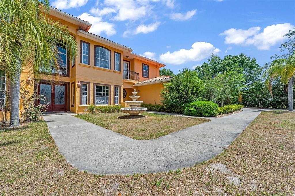 13161 Lake Butler Boulevard Windermere, FL 34786 - Photo 4 of 30 a front view of a house with garden