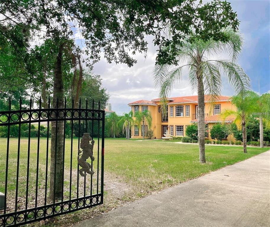 13161 Lake Butler Boulevard Windermere, FL 34786 - Photo 6 of 30 a view of a apartment with a big yard and potted plants and large trees
