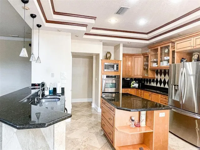 a kitchen with kitchen island a sink and a mirror
