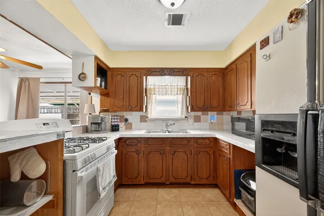 a kitchen with a sink stove and cabinets