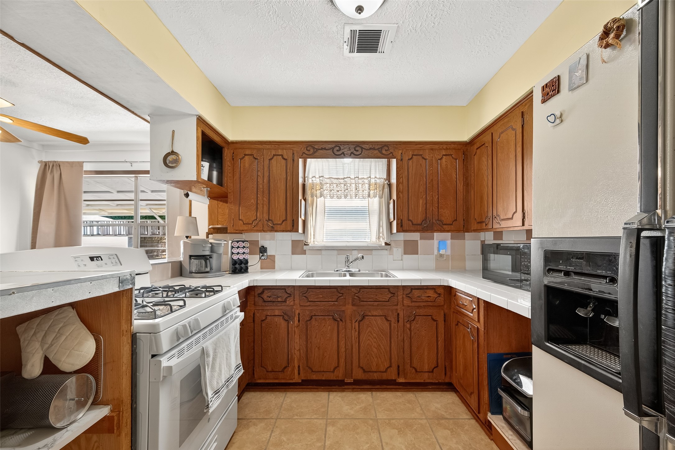 4802 Mistletoe Road Pasadena, TX 77505 - Photo 18 of 41 a kitchen with a sink stove and cabinets