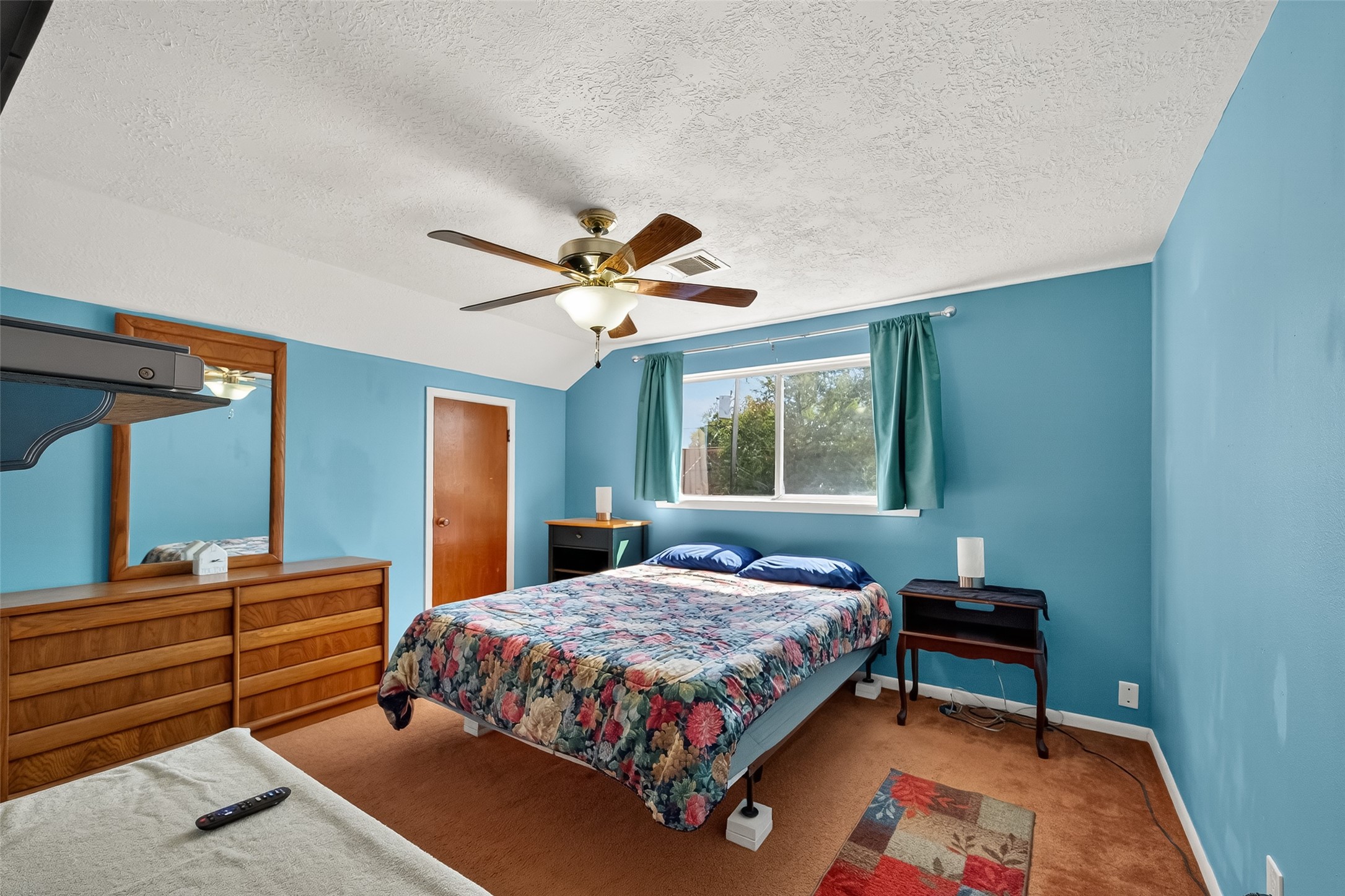 4802 Mistletoe Road Pasadena, TX 77505 - Photo 25 of 41 a bedroom with a bed and a chandelier