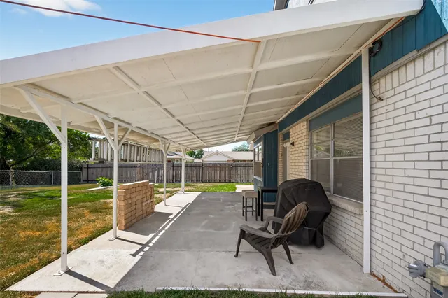 a view of a swimming pool with a patio and a yard