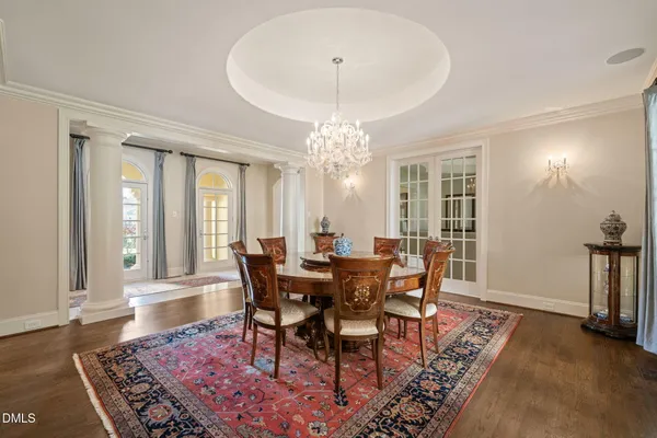 a living room with furniture kitchen view and a large window