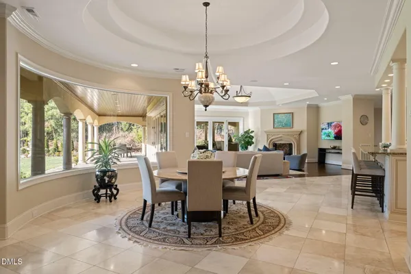 a living room with furniture and a fireplace with wooden floor