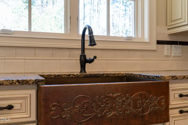 a view of empty room with wooden floor and fireplace