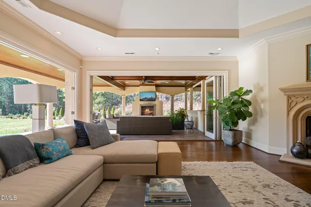 a spacious bedroom with a large bed and a chandelier