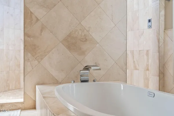 a bathroom with a granite countertop double vanity sink and a mirror