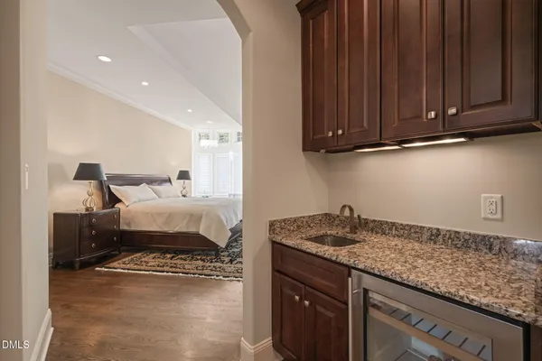 a front view of a house with a garden and trees