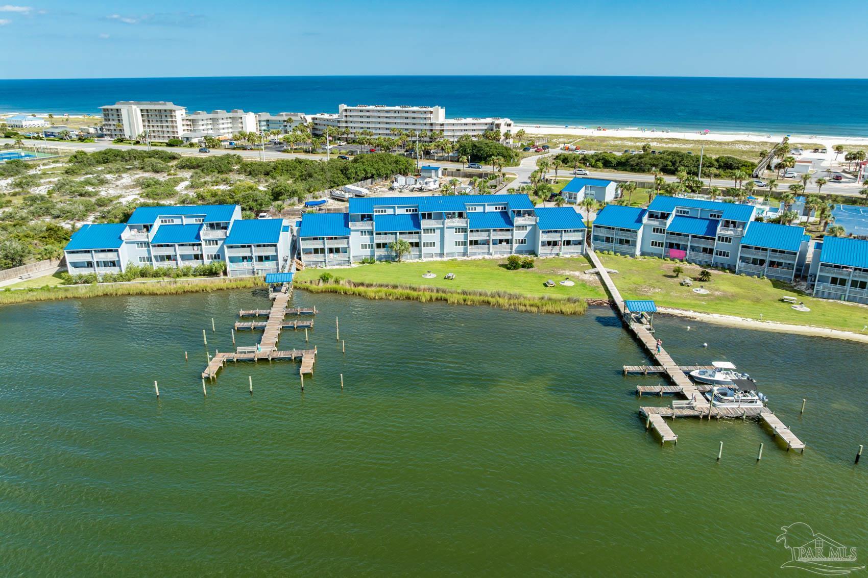 16470 Perdido Key Drive, Unit B13 Perdido Key, FL 32507 - Photo 1 of 17 a view of a swimming pool with lawn chairs