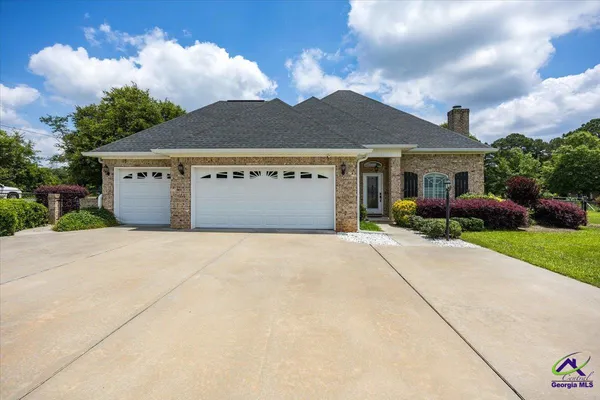 a front view of a house with a yard and a garage