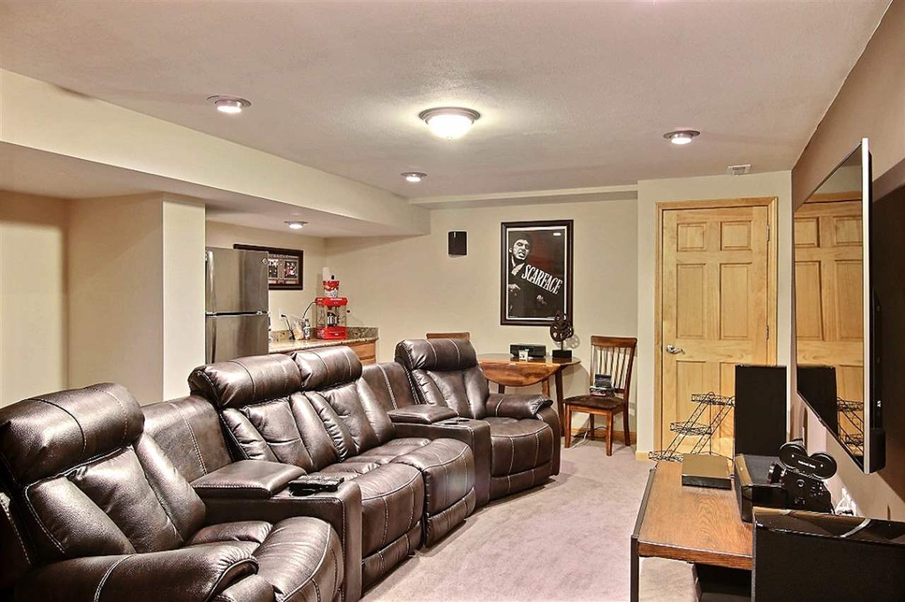 15813 Prairie Road South Beloit, IL 61080 - Photo 16 of 22 a living room with furniture a flat screen tv and a window
