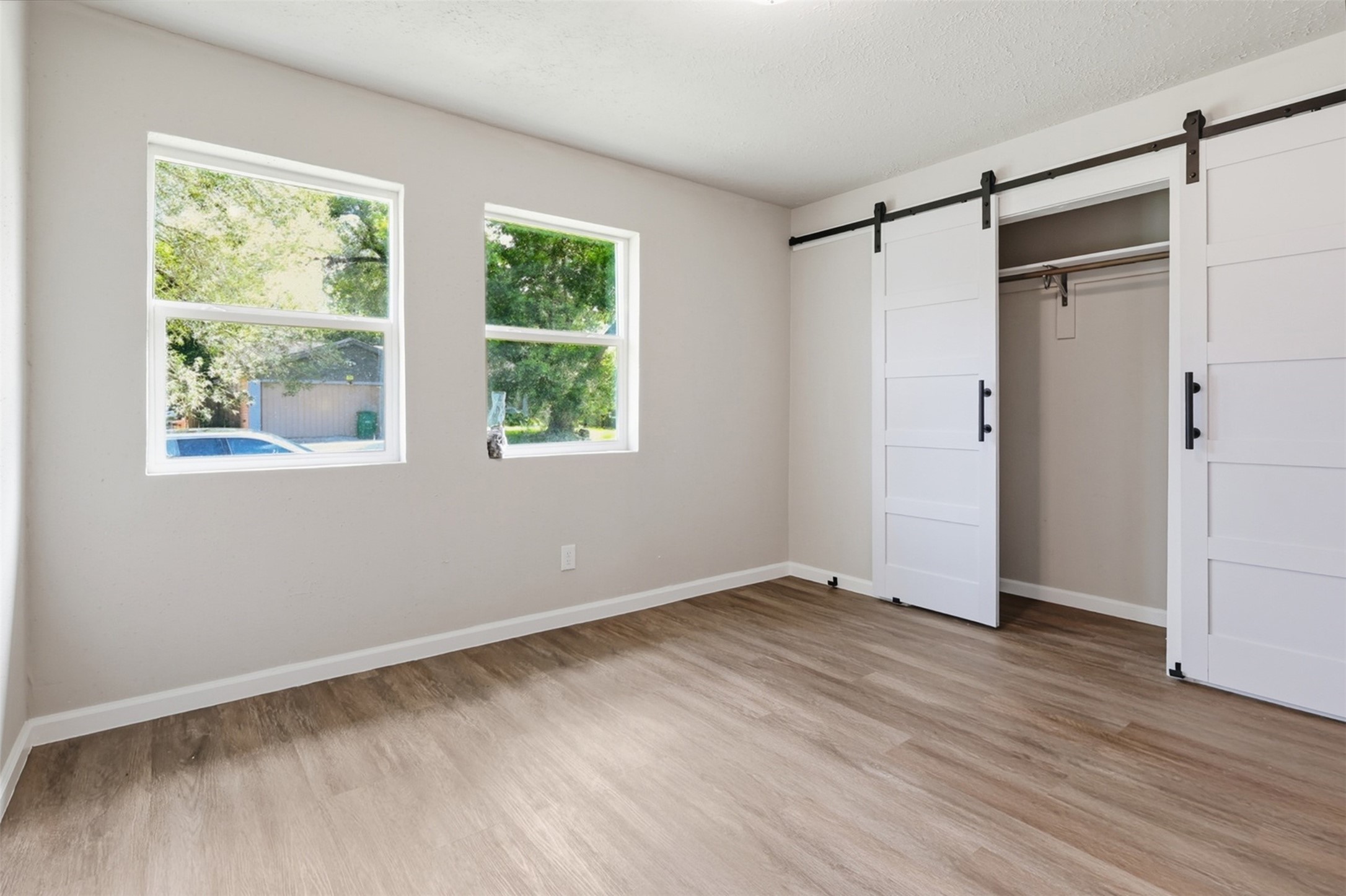 4767 Beechaven Street Houston, TX 77053 - Photo 20 of 26 a view of an empty room with wooden floor and a window