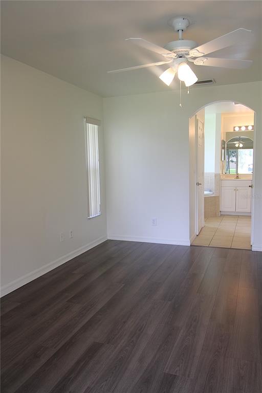 1489 Exchange Avenue North Port, FL 34288 - Photo 13 of 25 an empty room with wooden floor and windows
