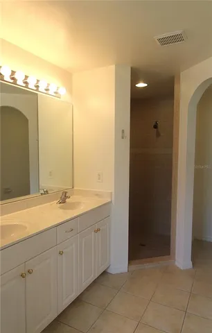 a bathroom with a double vanity sink and mirror